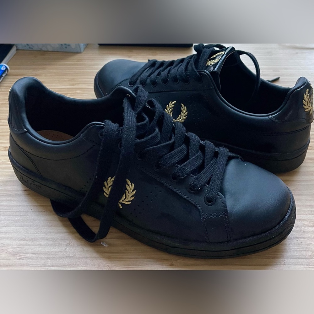 Designer sneakers by Fred Perry. Size 9. Wore once and comes with box.